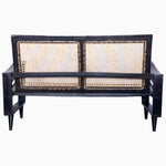 A Vintage Furniture black loveseat with wavy arms and a restored rattan seat. - 29225305538606
