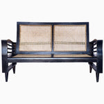 A Vintage Furniture black loveseat with wavy arms, showcasing beautifully restored cane work. - 29225305604142