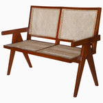 A Jeanneret Loveseat by Vintage Furniture, with a rattan seat. - 29225394995246