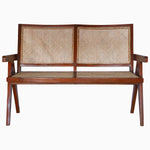 A Jeanneret Loveseat with a rattan seat by Vintage Furniture. - 29225395060782