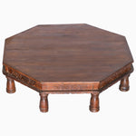 An octagonal John Robshaw Naga tribal coffee table with carved legs, crafted from hardwood. - 29224434008110