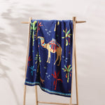 A 100% cotton Dhule Indigo Beach Towel with a camel on it by John Robshaw. - 29274374602798