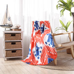 A Sashpura Coral Beach Towel by John Robshaw is sitting on a chair in a room. - 29274373980206