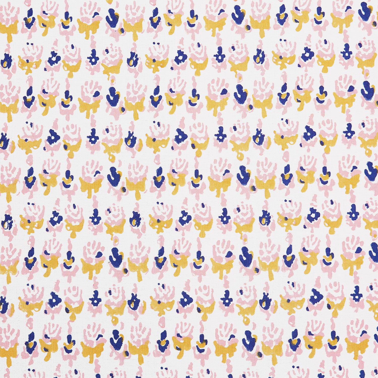 A close up of a Kiki Oyster Fabric hand block printed pink, blue and yellow flower batik by John Robshaw.