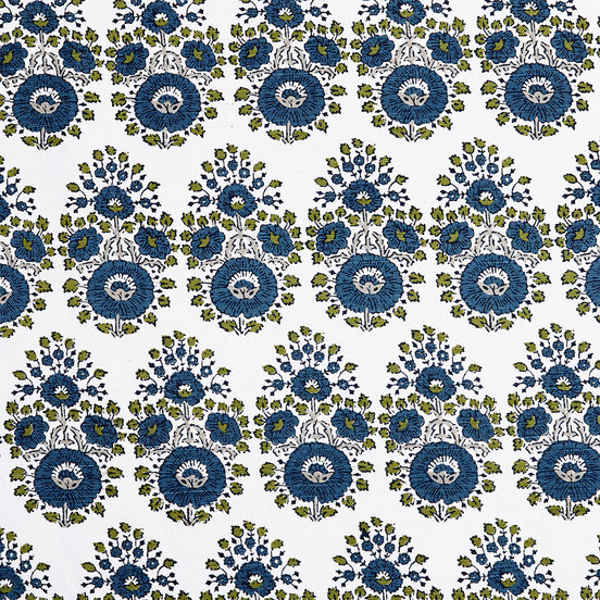 A blue and green floral pattern on a white background featuring traditional craftsmanship of the Lanka Peacock Fabric by John Robshaw.
