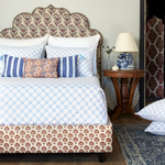 A blue and white bedroom with a bed, pillows, and John Robshaw Layla Azure Quilts. - 30262778363950