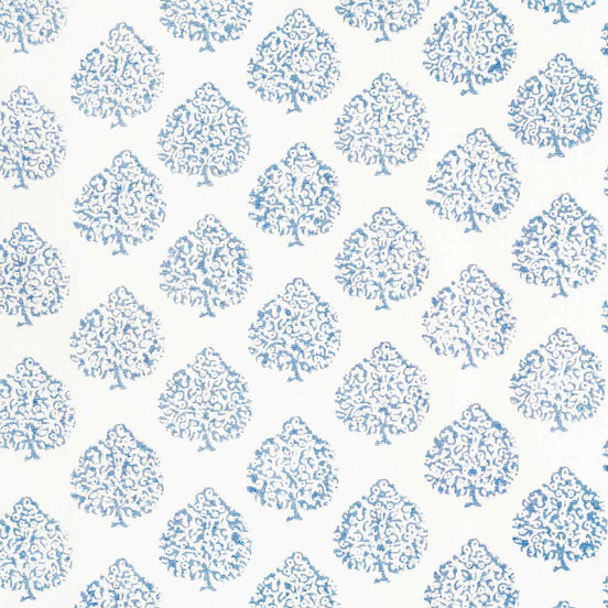 This Mali Light Indigo Fabric by John Robshaw showcases a beautiful blue and white tree pattern on a crisp white background, highlighting the traditional craftsmanship involved in creating this design.