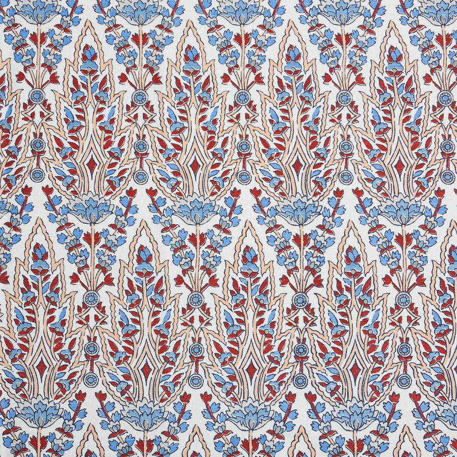 A beautiful blue and red floral pattern resembling the blooming gardens of Mughal, hand block printed on a pristine white background using the Marmar Coral Fabric by John Robshaw.