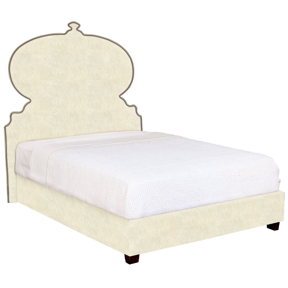 A Custom Orissa bed with an ornate headboard and footboard available for white glove delivery by John Robshaw.