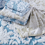 A set of Pasak Linen Bath Towels by John Robshaw on a blue background. - 28533991505966
