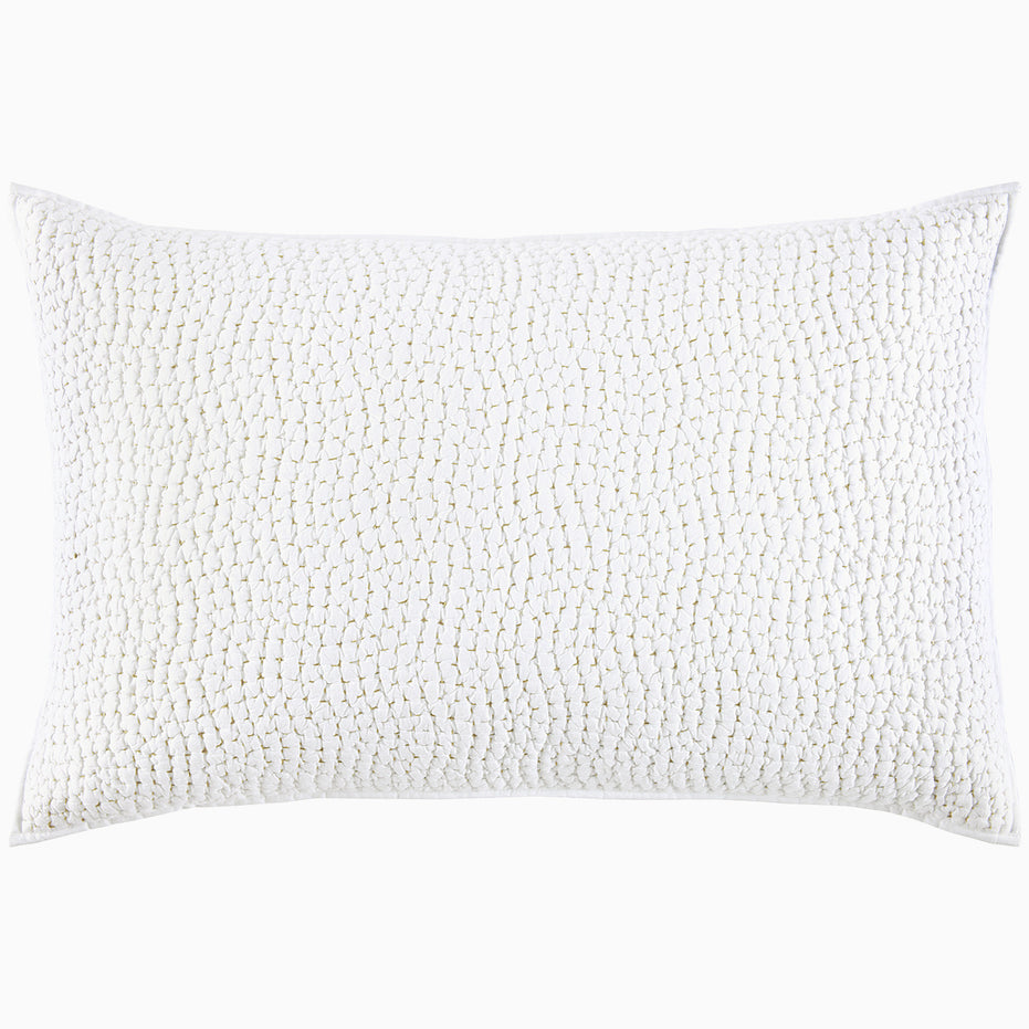 A white pillow with hand stitching and organic cotton voile coverlets, featuring the Organic Hand Stitched Sand Quilt by John Robshaw.