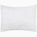 A white pillow with dots on it, made from cotton voile coverlets and hand-stitched. The Organic Hand Stitched Gray Quilt, made by John Robshaw. - 28009911386158