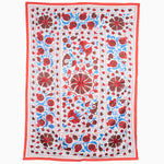 A beautifully embroidered tribal textile, known as Lanka Oyster Suzani Blanket from Central Asia. This wall hanging features vibrant floral designs in red, blue, and white by John Robshaw. - 30265272631342