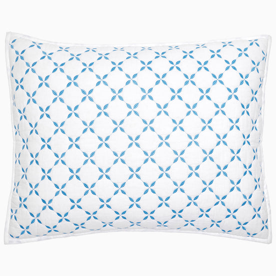 A Layla Azure Quilt pillow by John Robshaw with a blue and white geometric pattern.
