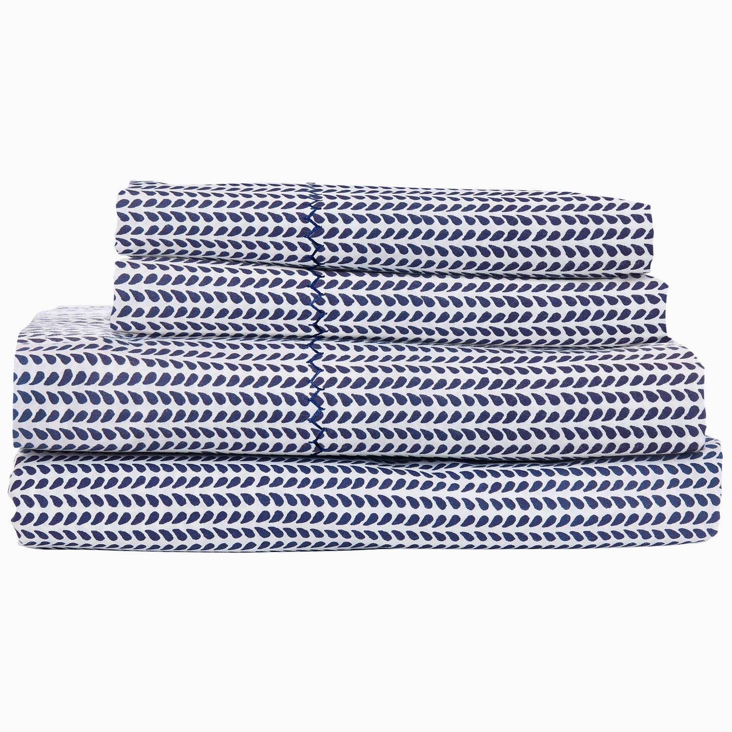 A stack of 200 Cinde Indigo Organic Sheet Set by John Robshaw, indigo and white patterned sheets.