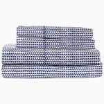 A stack of 200 Cinde Indigo Organic Sheet Set by John Robshaw, indigo and white patterned sheets. - 29385978380334