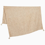 A Chahan Throw towel with tassels, hanging on a white background by John Robshaw. - 29981031563310