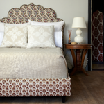 A bed with an ornate headboard adorned with Vivada Sand Woven Quilts from the Quilts & Coverlets brand. - 30262782427182