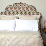 A bed with an ornate headboard and pillows, featuring John Robshaw Stitched Sand Organic Sheets. - 30264081350702