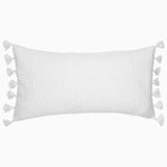 A Sahati White Bolster pillow with tassels on it by John Robshaw. - 28779329585198