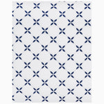 A Layla Indigo Quilt with blue and white flowers on it by John Robshaw. - 28799584698414