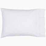 A white pillow with pink piping and embroidered designs on John Robshaw's Stitched Blush Organic Sheets. - 28765998645294