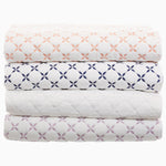 A stack of Layla Lavender quilts made by John Robshaw. - 28766508941358