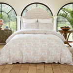 A bed with a colorful paisley pattern on it made from the Sana White Organic Sheet Set by John Robshaw. - 28783130804270