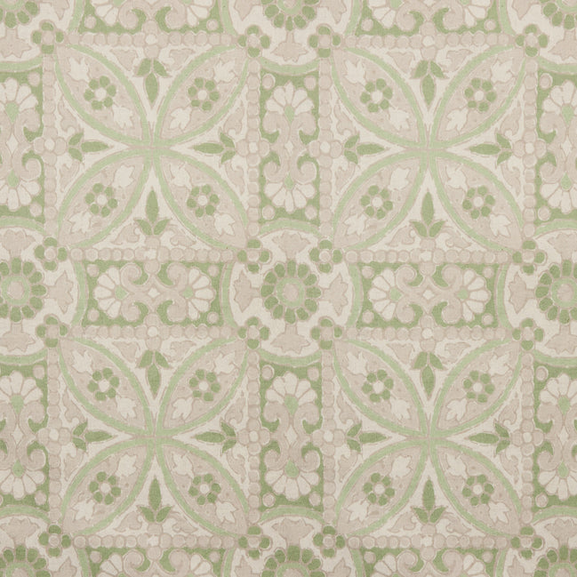 A printed green and white tile pattern with a floral design on John Robshaw's handmade Oman Sage Fabric.