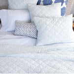 A reversible bed with Sagana Lapis Quilt by Quilts & Coverlets and cotton slub pillows. - 28783138275374