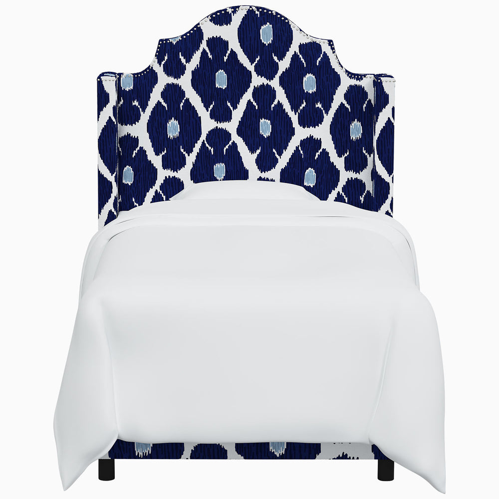 The John Robshaw Samrina bed features a headboard adorned with a beautiful blue and white pattern inspired by Mughal arches, designed by renowned artist John Robshaw.