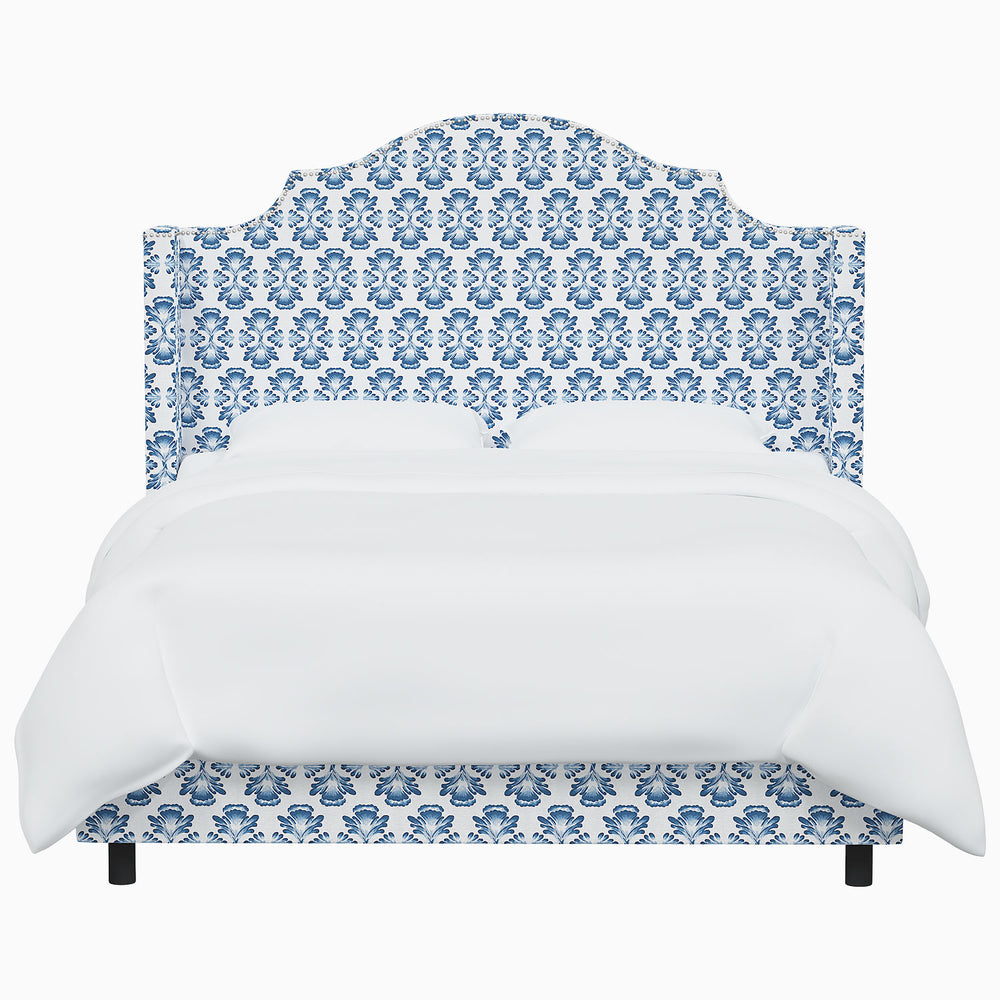The John Robshaw Samrina Bed features a stunning blue and white damask pattern, reminiscent of Mughal arches. This elegant design, created by renowned designer John Robshaw, adds a touch of