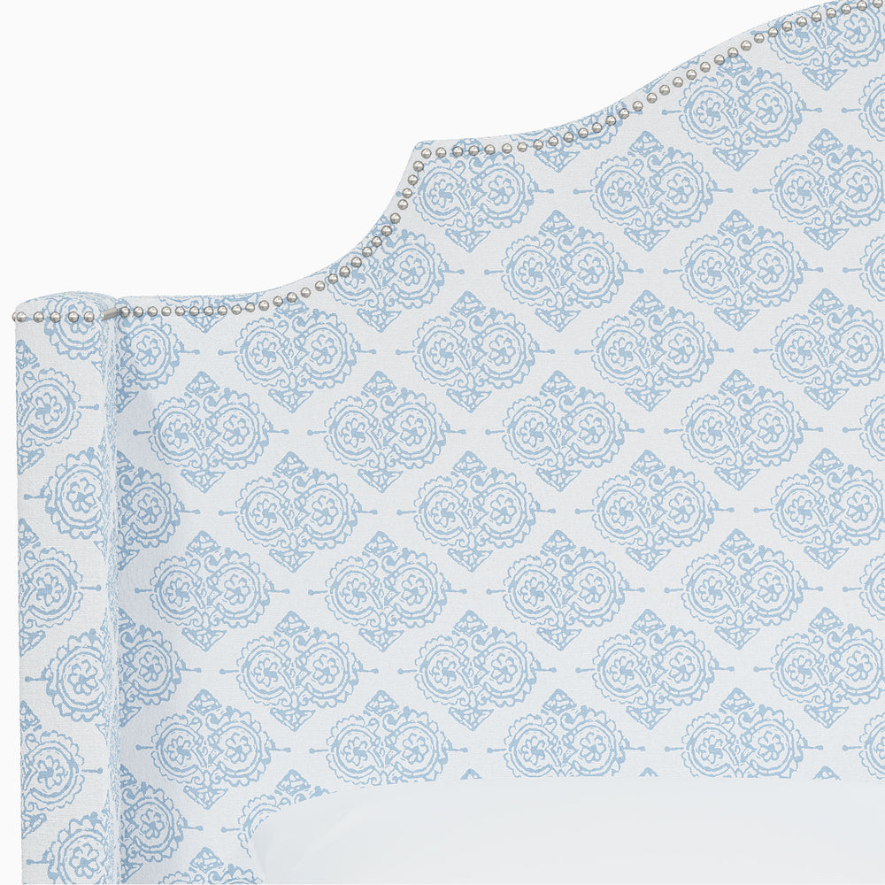 A Samrina bed by John Robshaw with a blue damask pattern featuring Mughal arches.