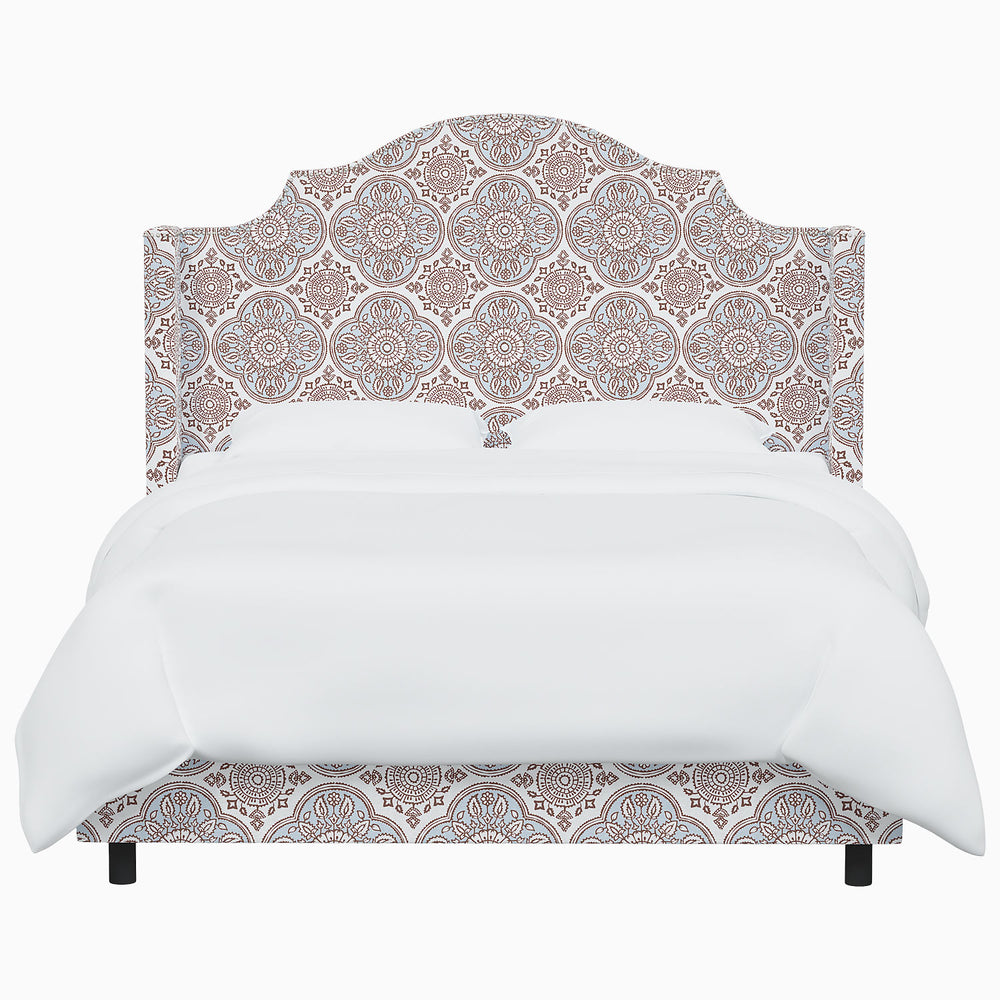 The John Robshaw Samrina bed, with its ornate headboard inspired by Mughal arches, showcases a striking white design.