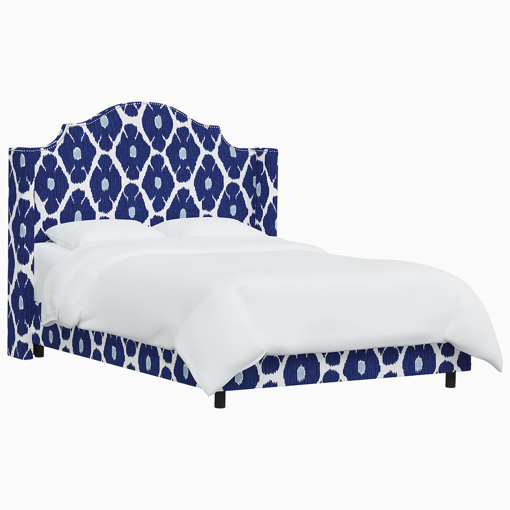The John Robshaw Samrina bed features a stunning blue and white patterned headboard, inspired by Mughal arches. Crafted with the exquisite attention to detail that John Robshaw is known for.