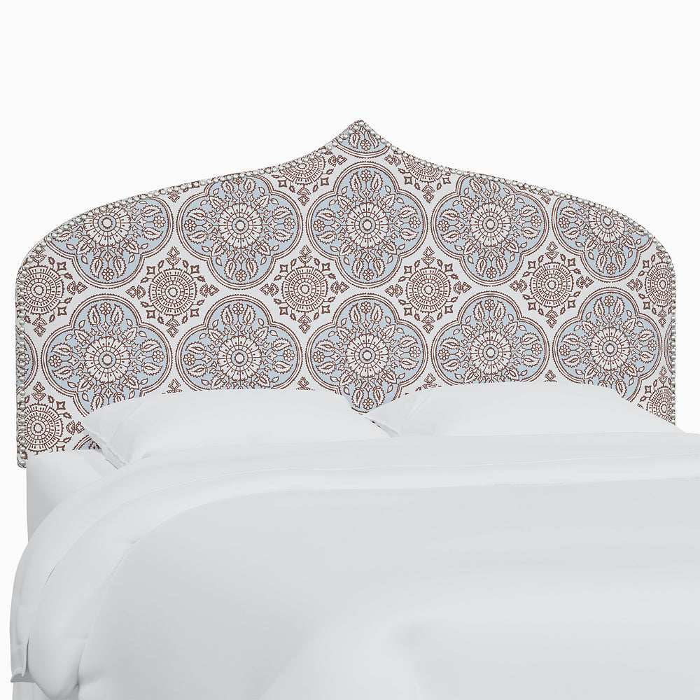 A John Robshaw Alina headboard with a blue and white Mughal arches print.