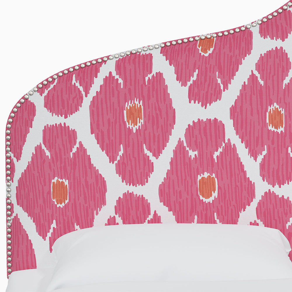 A beautiful bed with a pink and orange Mughal arches patterned headboard featuring John Robshaw Alina Headboard.