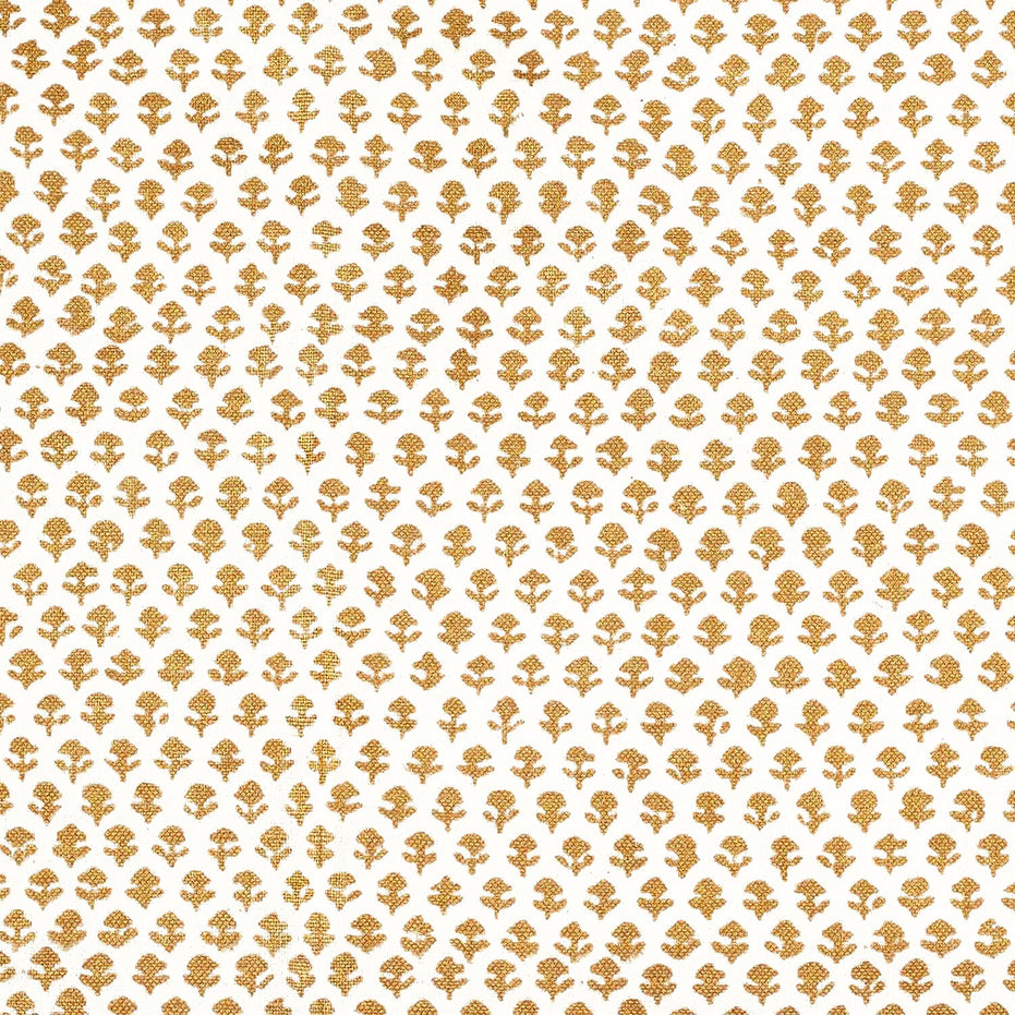 A Bindi Gold Fabric with a gold and white pattern on traditional hand block printed fabrics by John Robshaw.