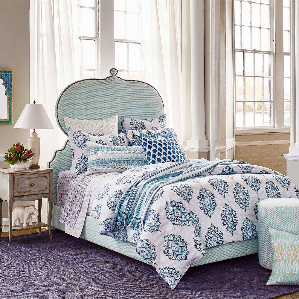 A Custom Orissa Bed by John Robshaw with a blue and white pattern available for shipping.