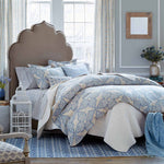 A bed with a John Robshaw Organic Hand Stitched Light Indigo Quilt made of cotton voile. - 15564936445998