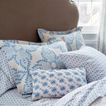 A bed with organic cotton Kama Gray Organic Sheet Set bedding and pillows in blue and white, featuring the John Robshaw print. - 11324204810286