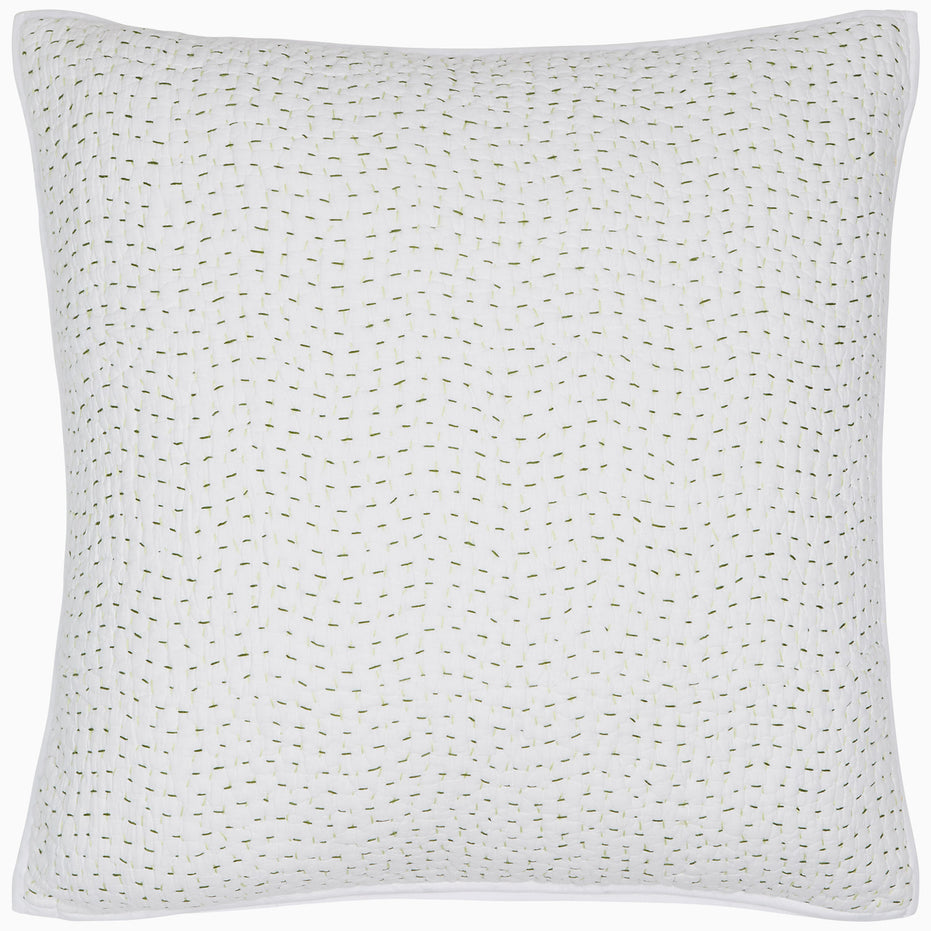 A white pillow hand stitched with gold dots on a John Robshaw Organic Hand Stitched Moss Quilt.