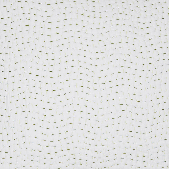A John Robshaw Organic Hand Stitched Moss Quilt Swatch with green dots on a cotton voile coverlet.