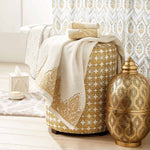 A John Robshaw Nadir Pearl White/ Gold Bath Towel jacquard bathroom with antique paisley towels and a gold vase. - 4128465092654