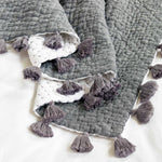 A Sahati Charcoal Throw blanket with tassels, machine washable by John Robshaw. - 4126813290542