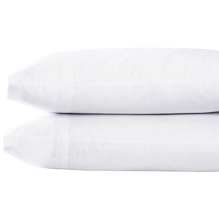 Two Anketi White Organic Sheet Set pillows from John Robshaw, stacked on top of each other.