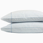 A pair of blue and white Kama Light Indigo Organic Sheet Set pillows on top of each other from the John Robshaw brand, featuring Kama print. - 28202299457582
