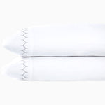 A pair of Stitched Gray Organic Sheets pillowcases featuring embroidered designs, showcased on a white background, by John Robshaw. - 30271863390254