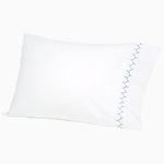 A white pillow with blue Stitched Indigo Organic Sheets and embroidered designs by John Robshaw. - 30271866798126