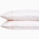 A pair of Poseti Lotus Organic Sheet Sets by John Robshaw, made with organic cotton, resting on a white background. These sheet sets are machine washable.